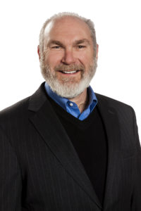 Ed Wagner - man in a black suit coat, grey hair, and a beard